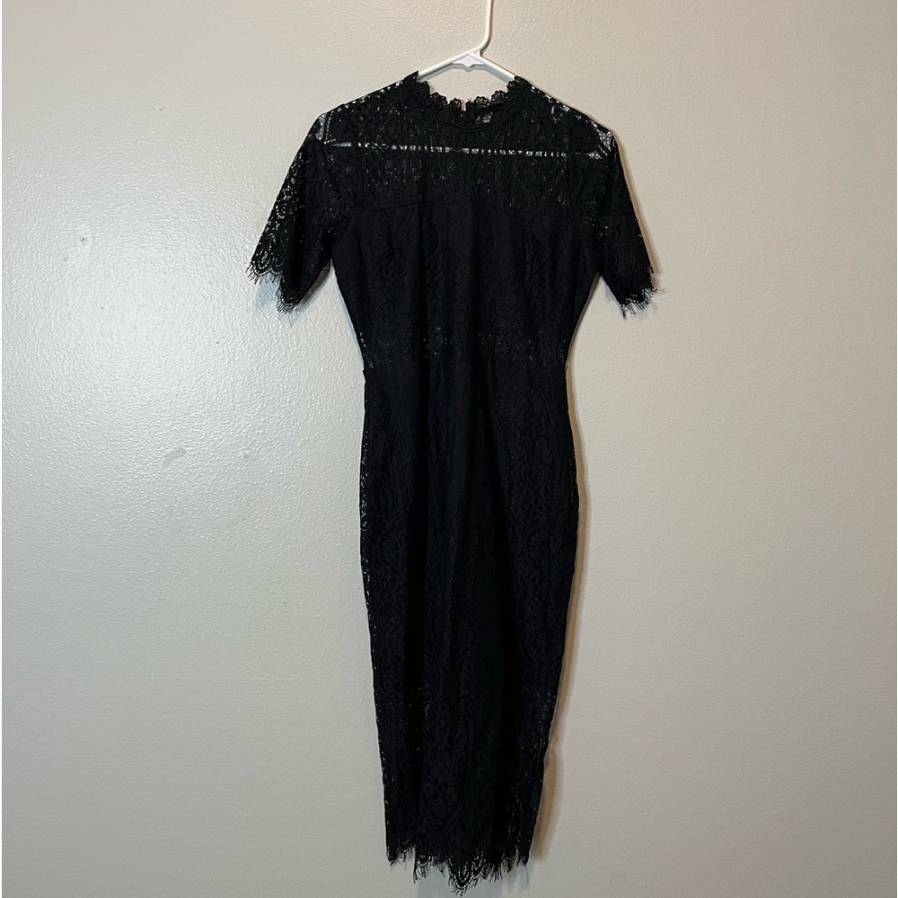 Sort of a Lacey style black dress, fitting for work or brunch
